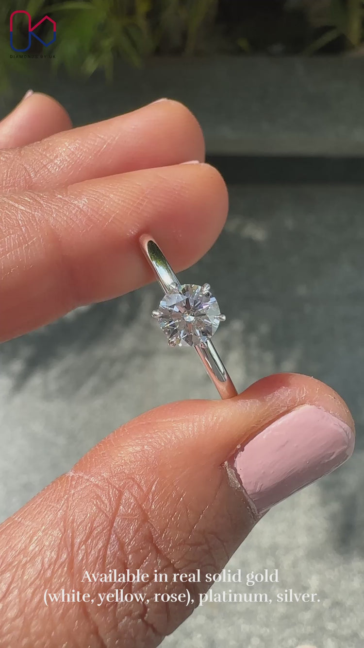 Round cut diamond ring set in a secure solitaire setting ring for maximum brilliance.