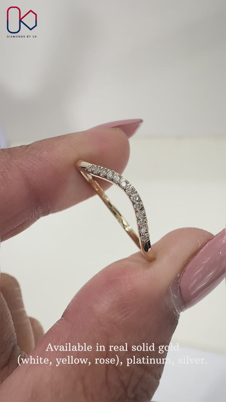 Elegant curved diamond wedding band featuring brilliant diamonds.

