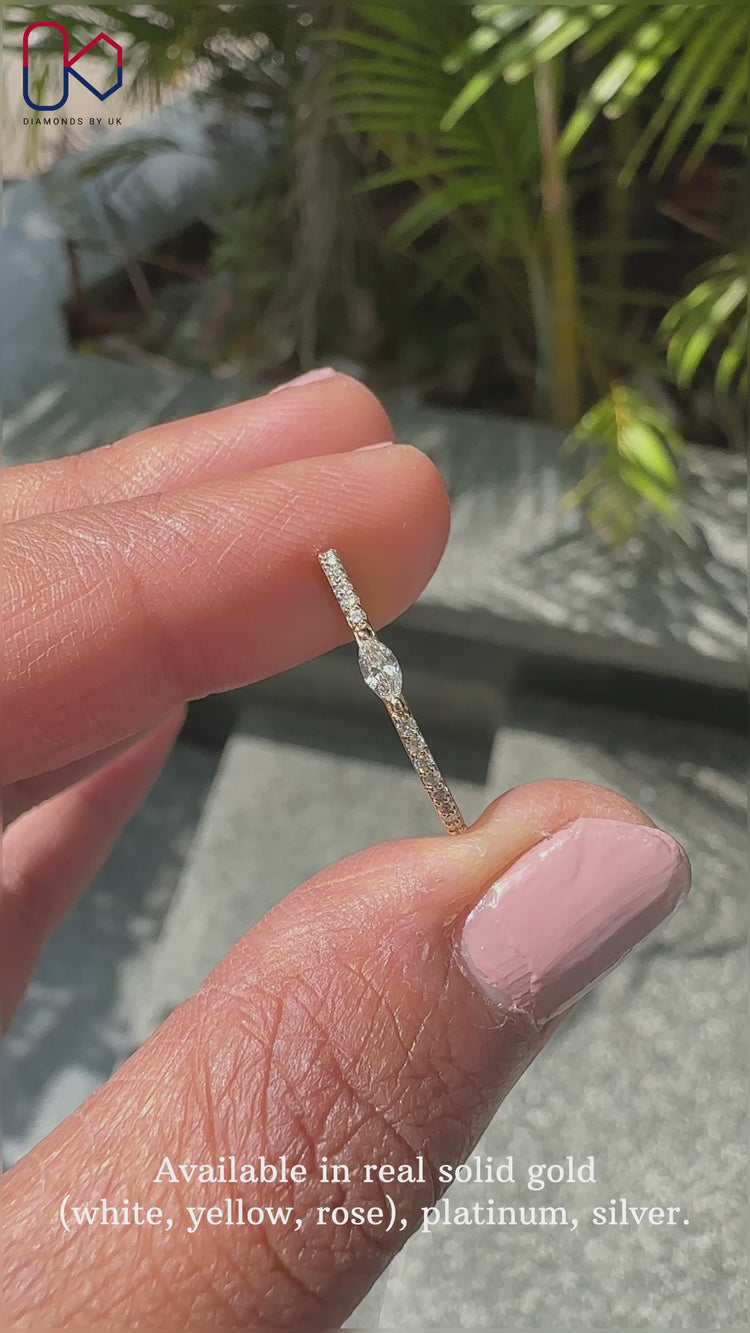 Marquise cut band with prong set diamonds for elegant style.
