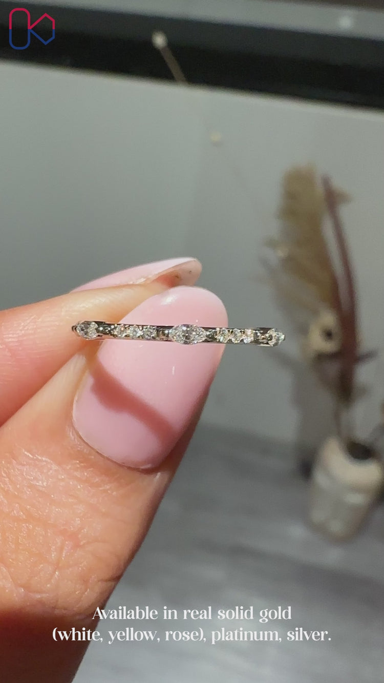 Marquise diamond wedding band designed with alternating stones for a soft, graceful curve.
