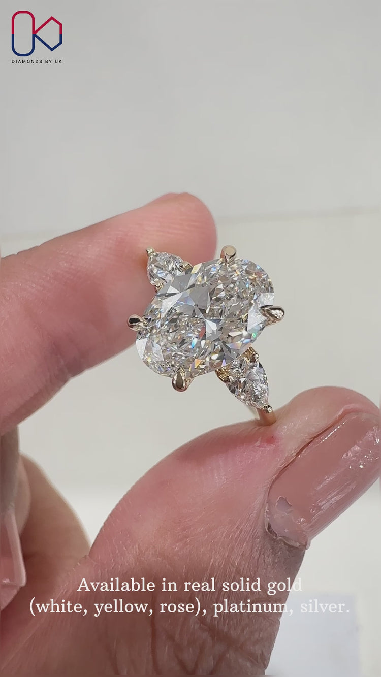 Oval diamond ring set in a yellow gold engagement ring with 4 prong claw setting.
