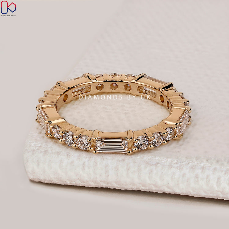 Lab grown baguette and round diamond eternity wedding band.