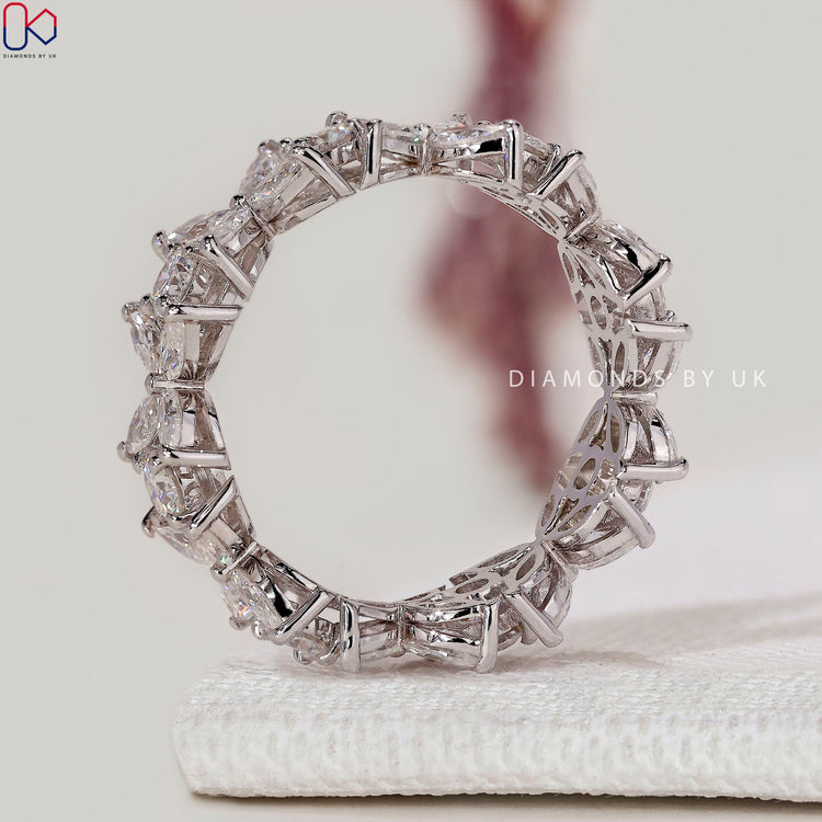 Floral style wedding band with round and marquise diamonds.