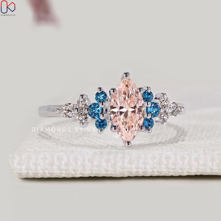 Marquise ring with round and pear side stones
