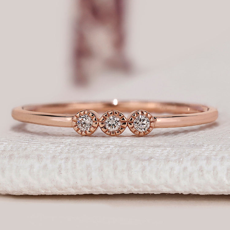 Round diamond wedding band with three stone style.

