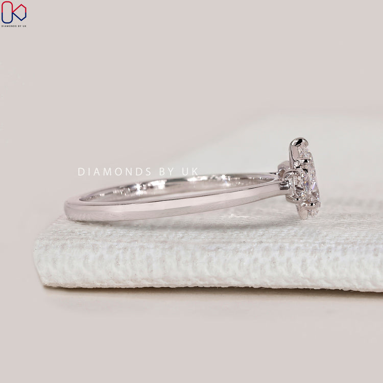 Pear lab grown diamond ring with round side stones.
