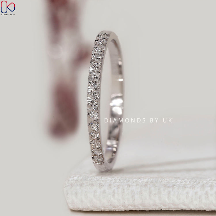 Round diamond wedding band with prong setting.