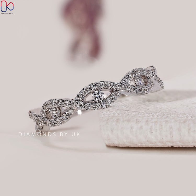 Round diamond half eternity band with twisted style.
