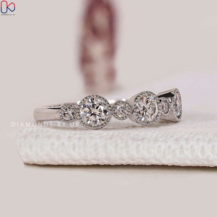 Half eternity band with round diamonds and milgrain bezels.
