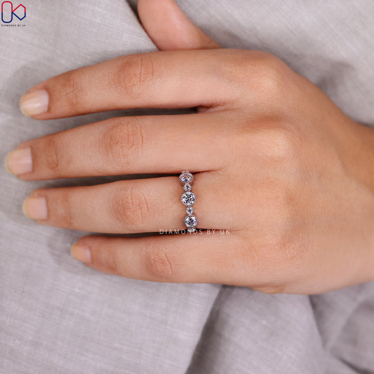 Handmade round diamond band with milgrain bezel set stones.
