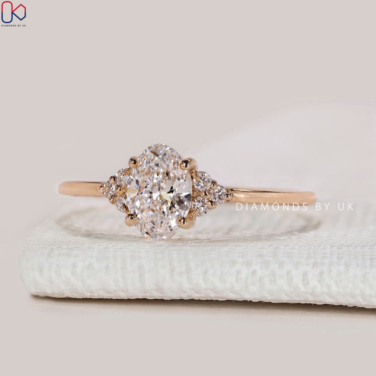 Oval cut lab grown diamond ring with side stones.
