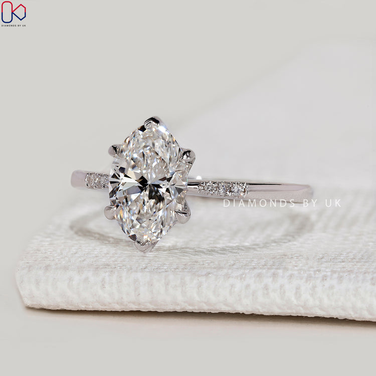 Oval cut lab grown diamond ring with side stones.