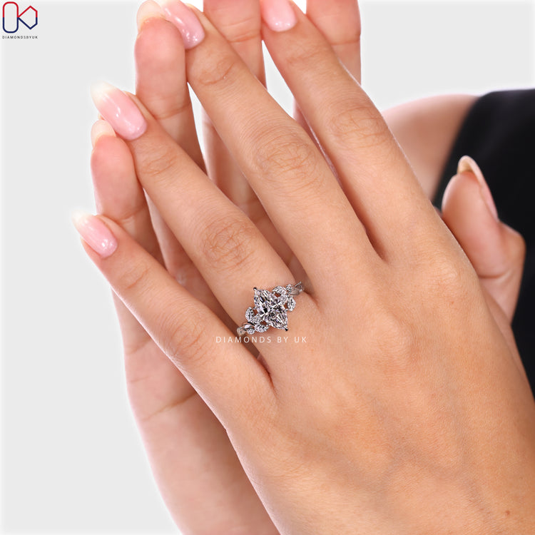 Nature inspired marquise ring with round diamond accents.

