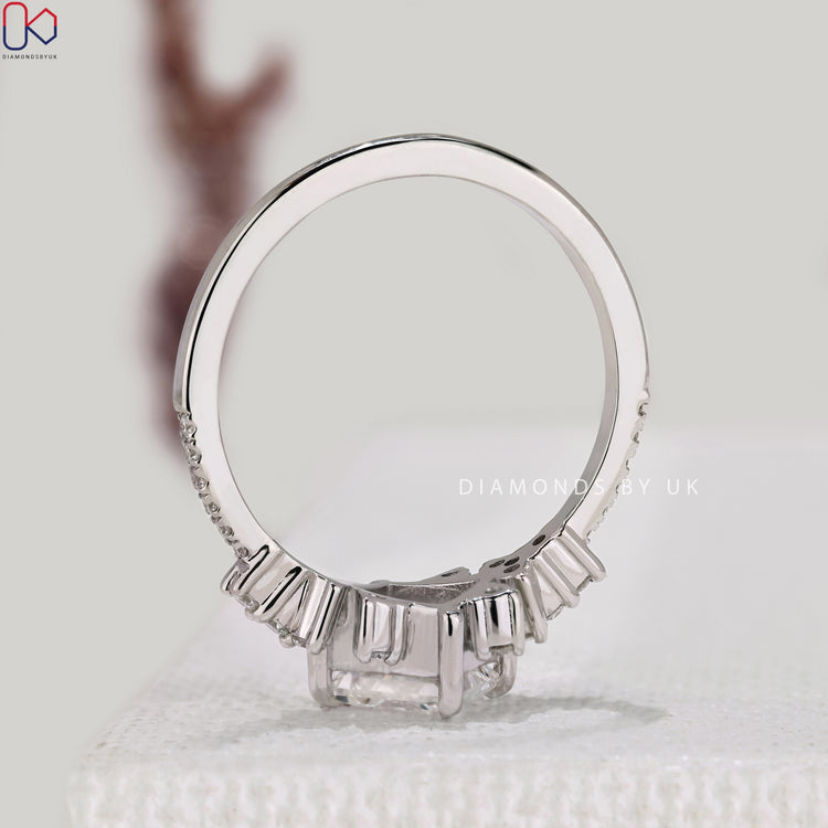 IGI certified princess diamond ring with side stones.
