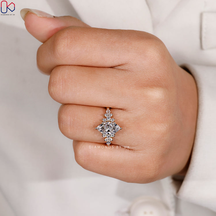 Muse setting marquise ring with pear side stones.
