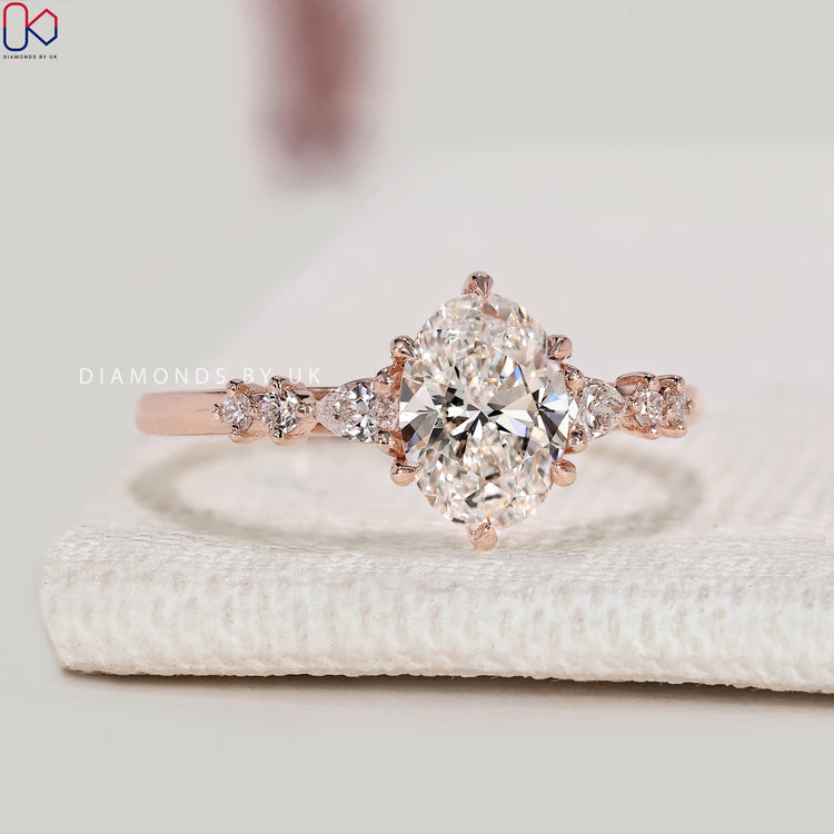 Oval cut diamond ring with six claw prong setting.
