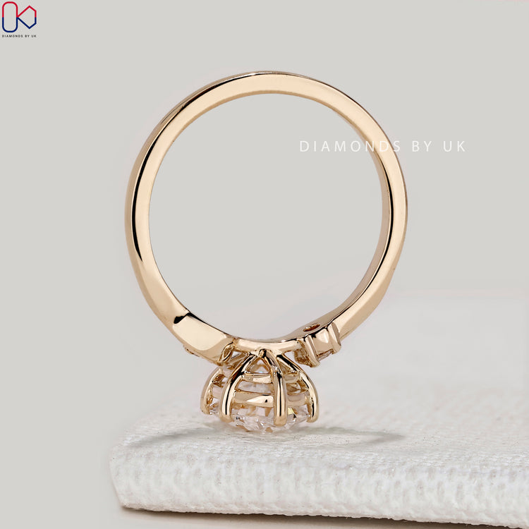 Oval ring with round side stones and three stones.