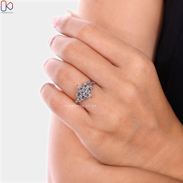 Lab grown marquise ring with round diamond side stones.
