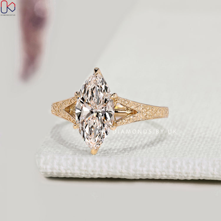 Marquise diamond solitaire ring with split shank design.
