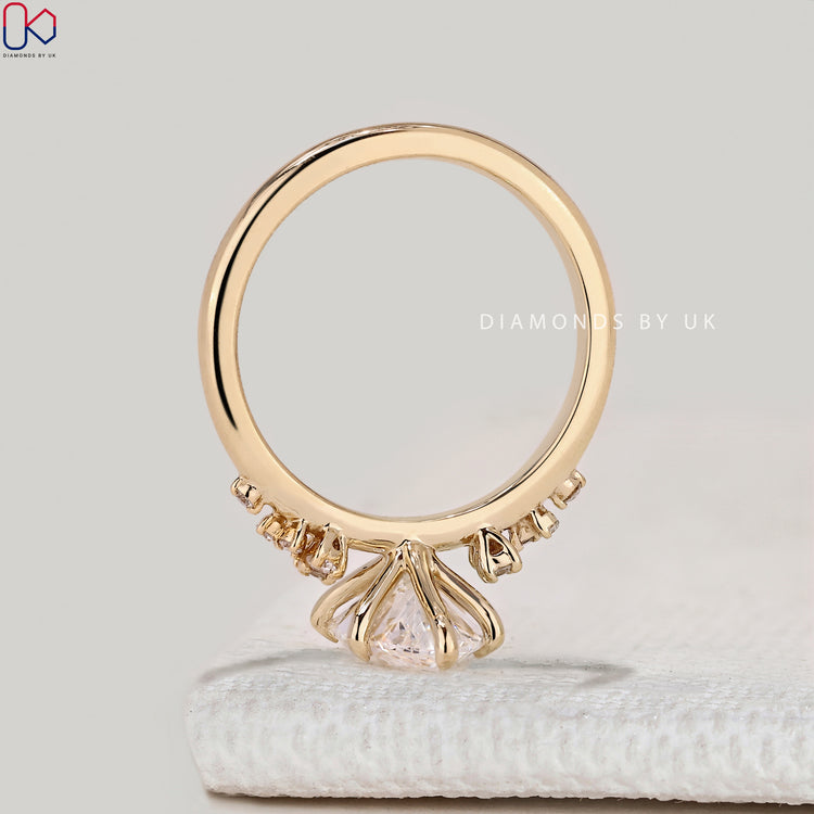 Marquise ring with round diamond cluster setting.