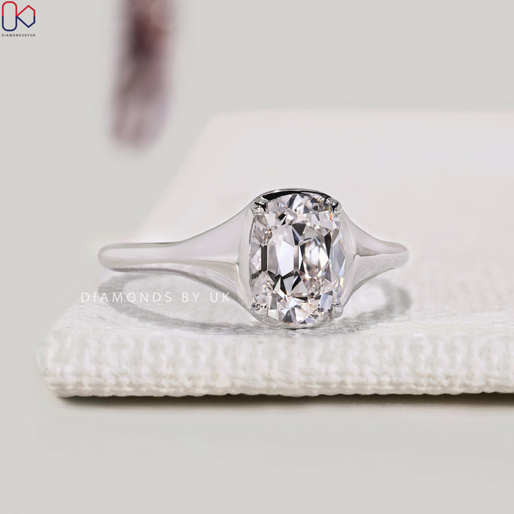 Lab grown Cushion Old European ring with claw prongs.
