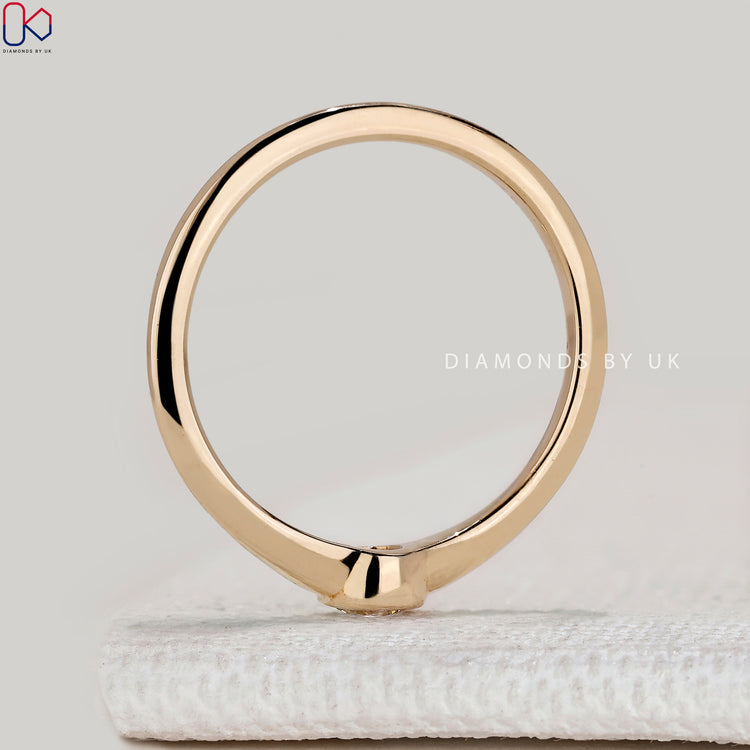 Round diamond solitaire ring with bezel setting.