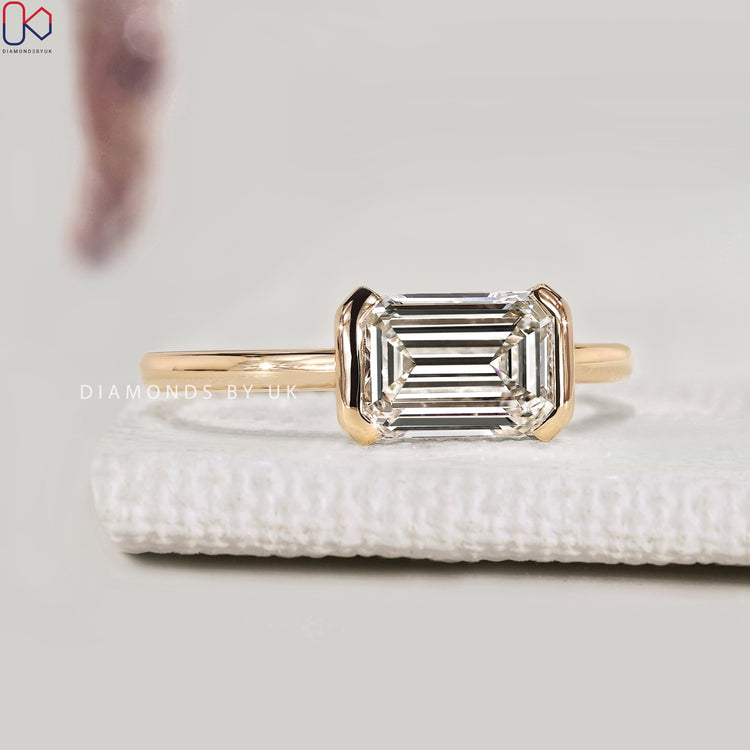 Handmade emerald cut diamond ring with half bezel
