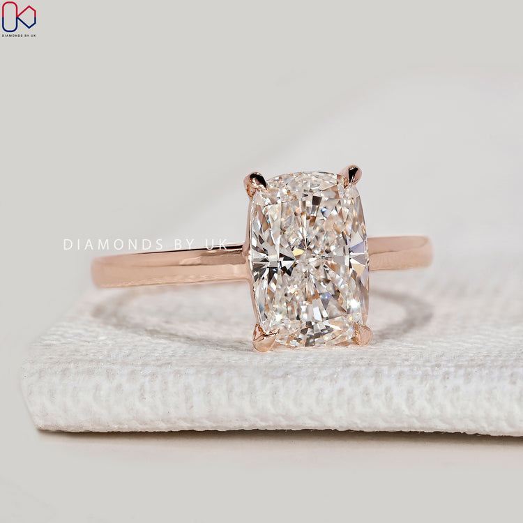 Cushion cut lab grown diamond ring with four claws.