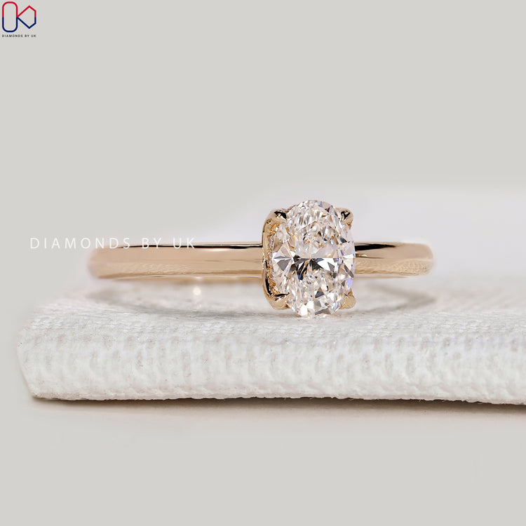 Oval lab grown diamond ring with tulip basket setting.