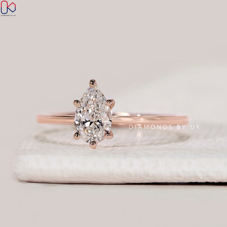 Pear cut lab grown diamond ring with six prongs.