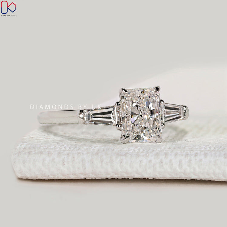 Pear lab grown diamond ring with round side stones.