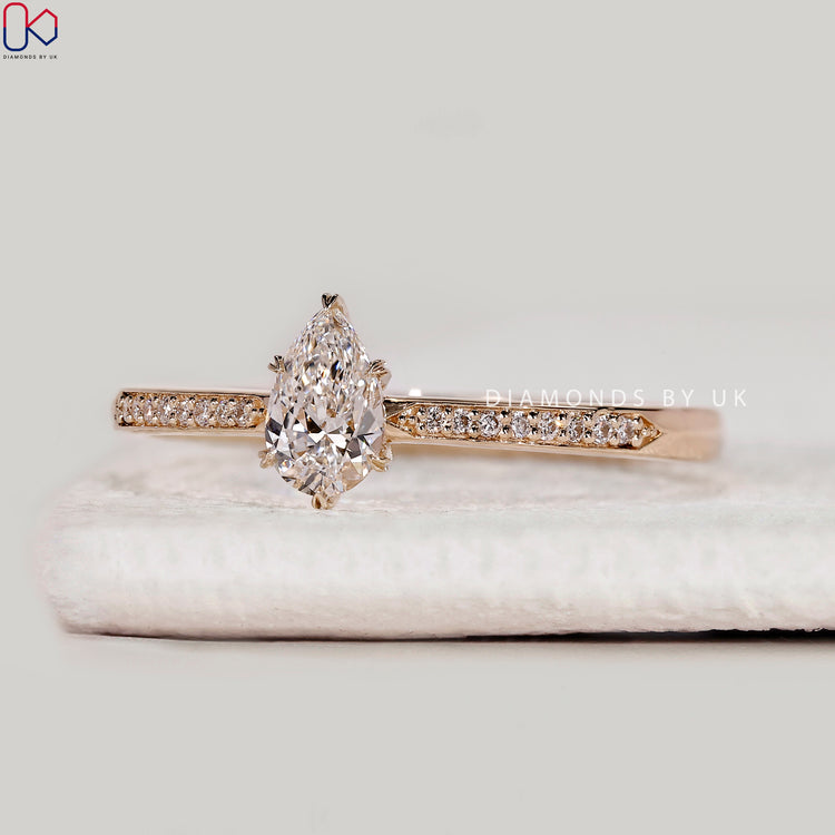 Pear cut lab grown diamond ring with heart prongs.