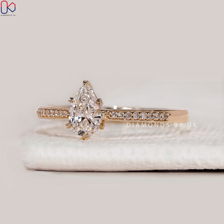 Pear cut lab grown diamond ring with heart prongs.