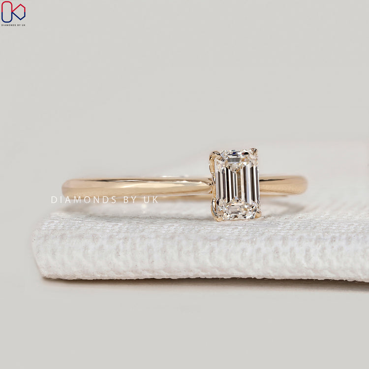 Emerald cut lab grown diamond ring with cathedral setting.
