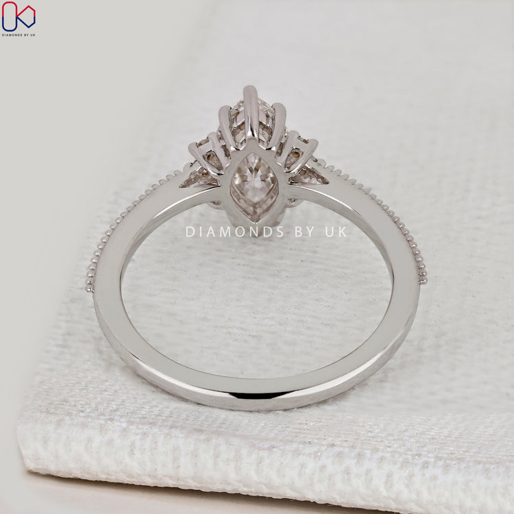 IGI Certified marquise diamond ring with milgrain.
