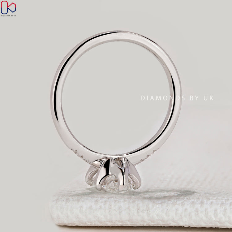 Oval cut ring with tapered shank and side stones.
