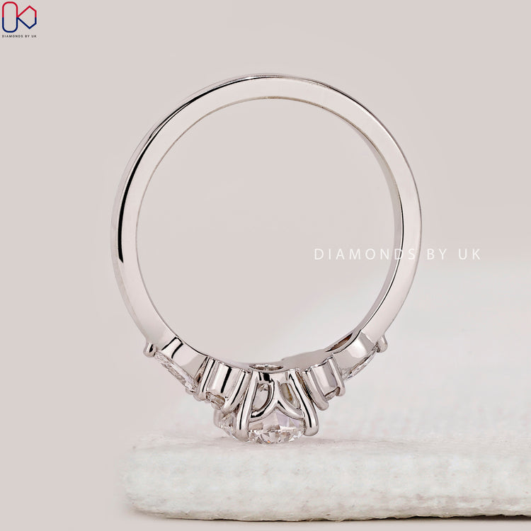 Round cut ring with marquise side stone design.