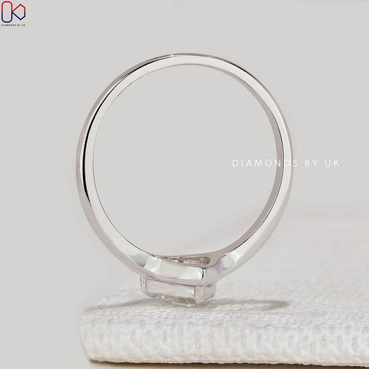Pear cut ring with tapered shank and bezel setting.