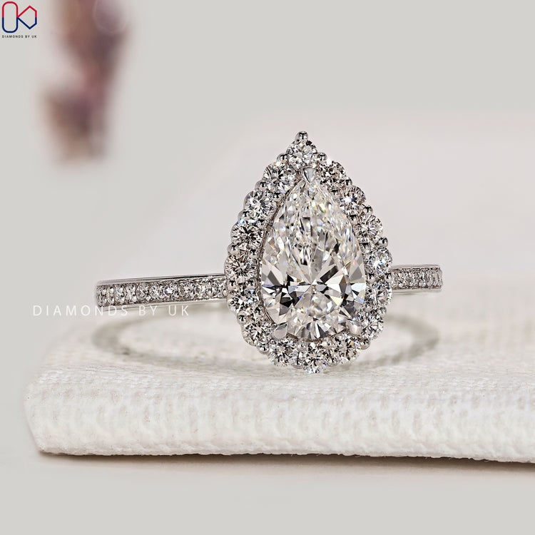Pear cut lab grown diamond ring with round pavé.