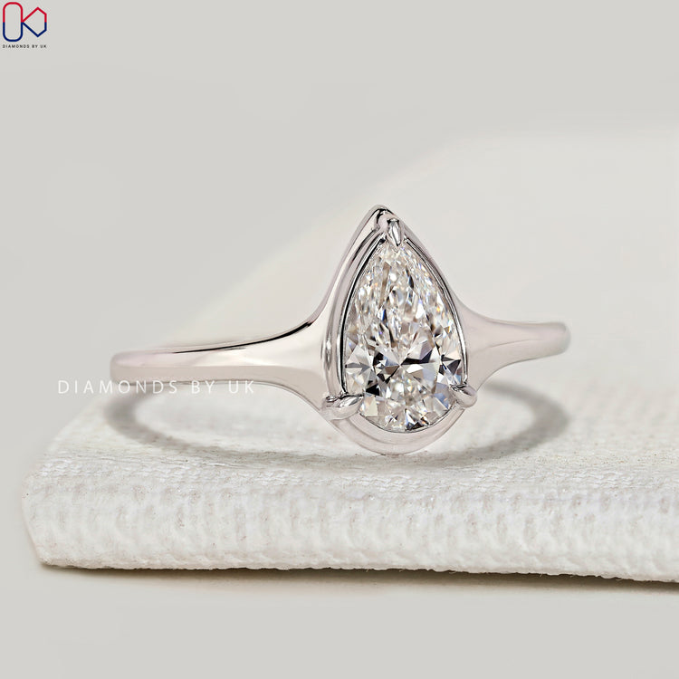 Pear cut lab grown diamond ring with tapered shank.
