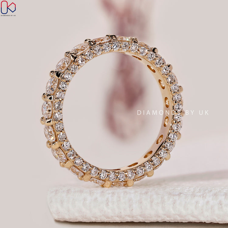 Handmade round cut diamond band with three sided eternity.