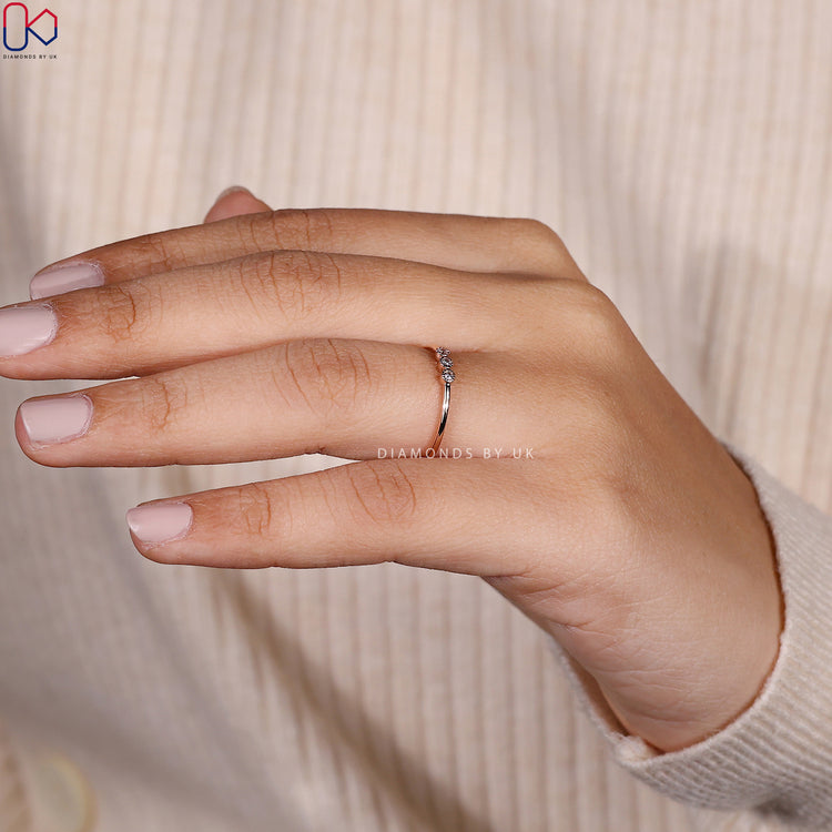 Round lab grown diamond wedding band with three stones.
