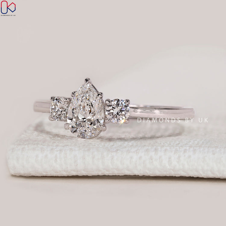 Pear lab grown diamond ring with round side stones.
