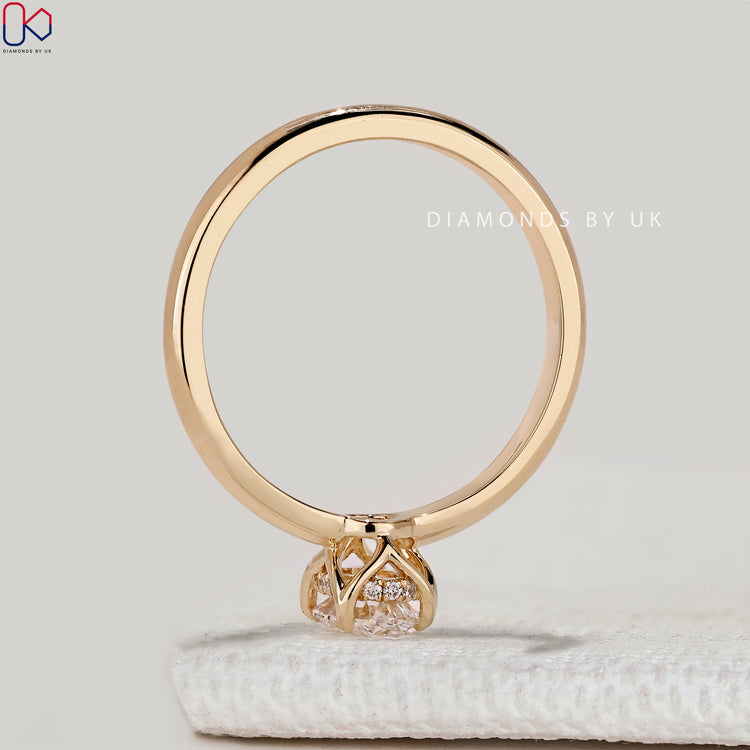 Oval ring with hidden halo and tulip basket setting.