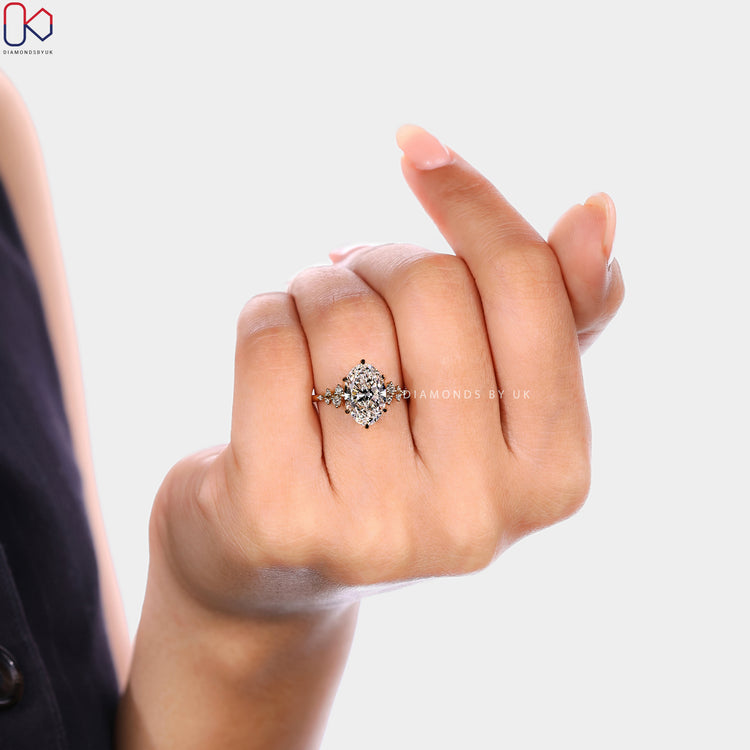 Oval cut diamond ring with muse and tulip setting style.  

