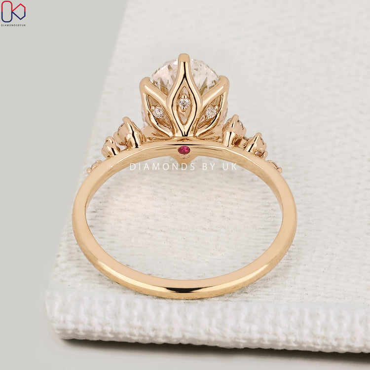 Handmade oval cut diamond ring with tulip setting style.  
