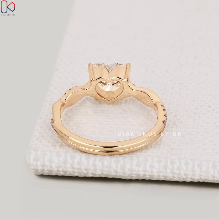 Handmade heart diamond ring with twisted pavé style.
