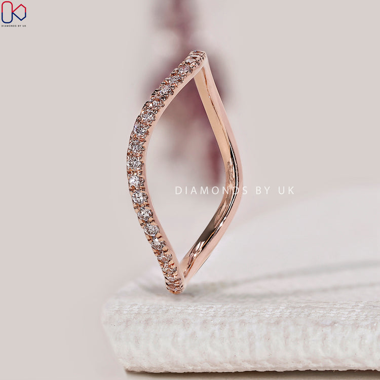 Round cut diamond band with a wave eternity design.
