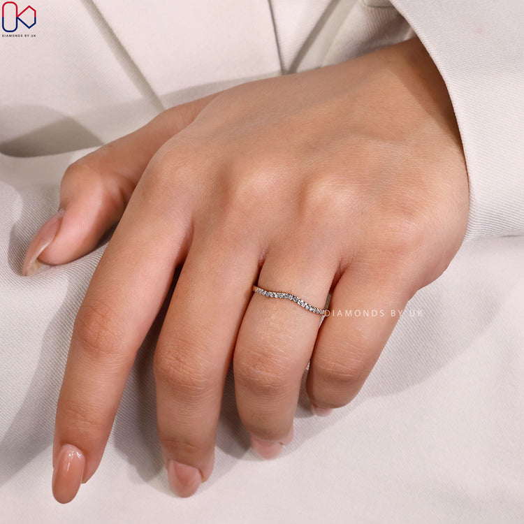 Curved half eternity band with round diamonds.